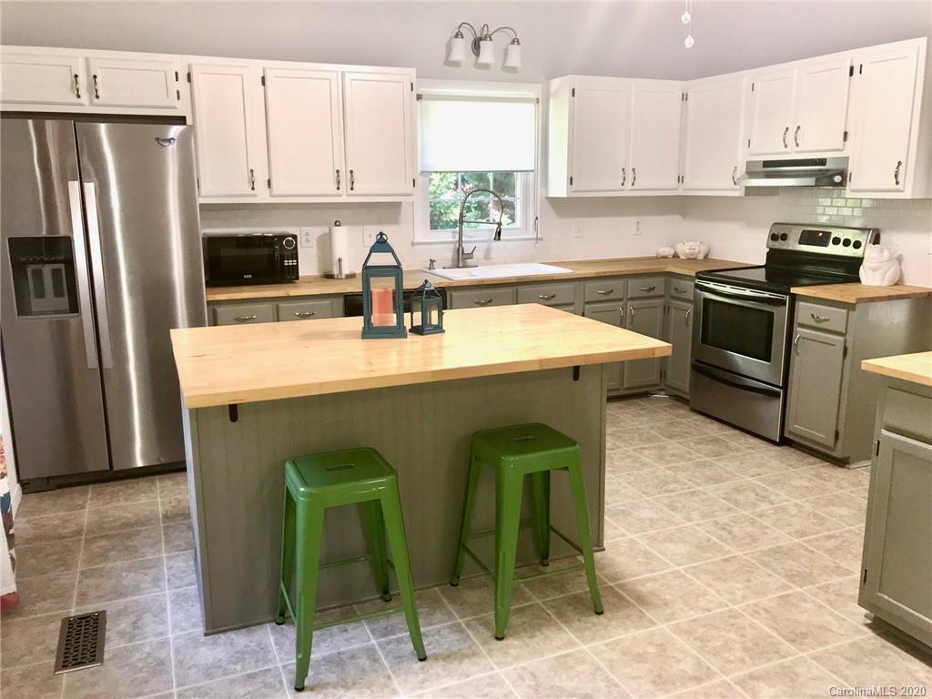 708 Trail Ridge Road Matthews, NC 28105 - Photo 6 of 40 a kitchen with kitchen island granite countertop a sink counter top space appliances and cabinets