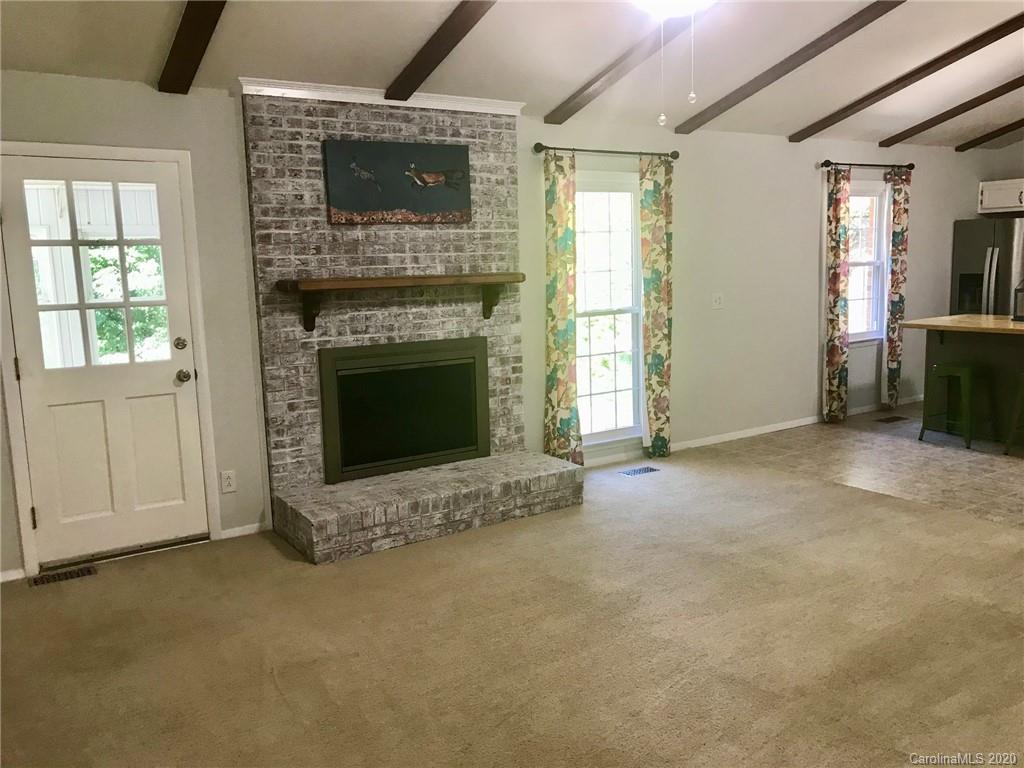 708 Trail Ridge Road Matthews, NC 28105 - Photo 10 of 40 an empty room with furniture and a fireplace
