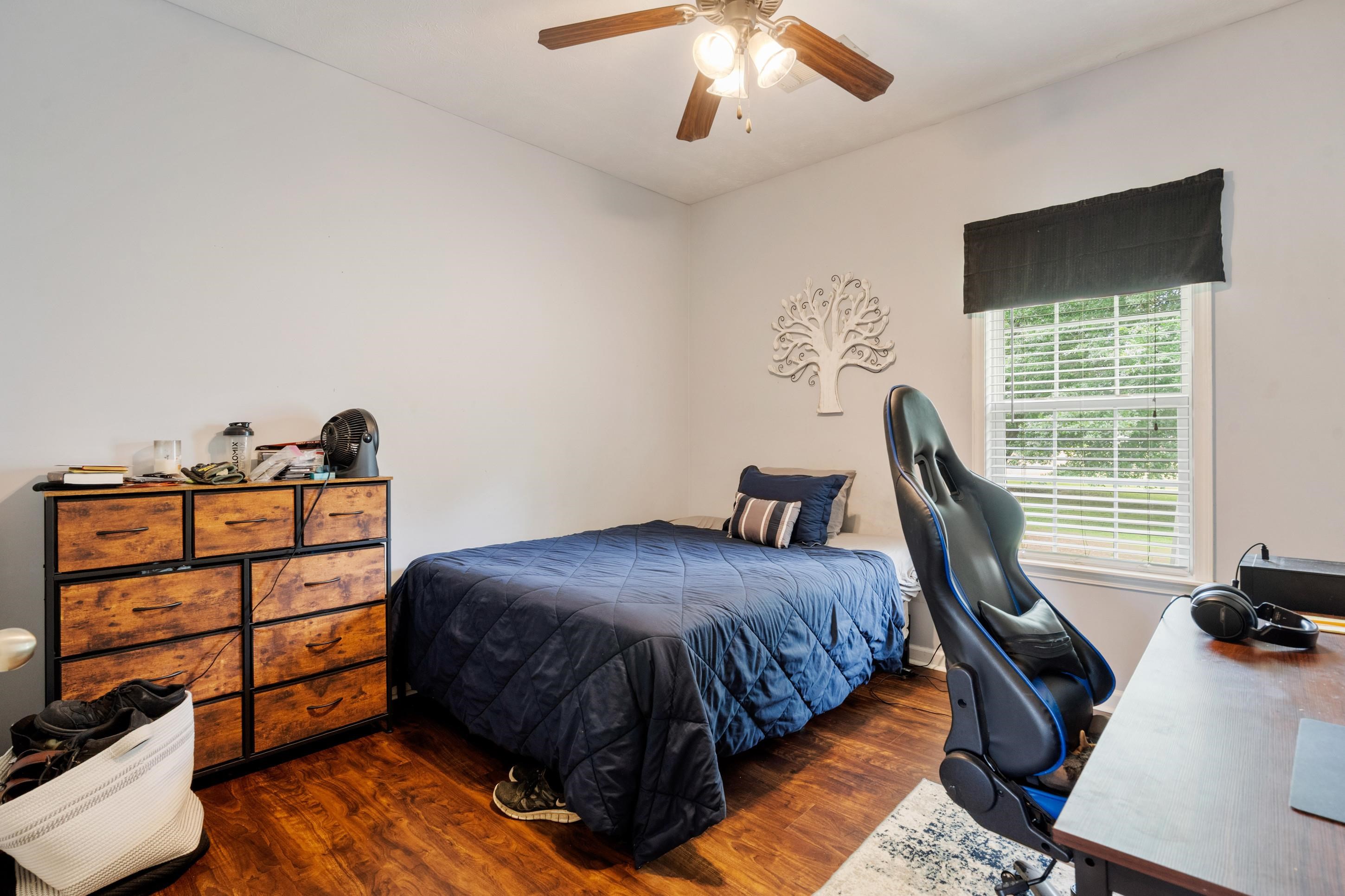 7757 Brunswick Road Millington, TN 38053 - Photo 15 of 40 Bright room with wood-finish flooring, a ceiling fan with integrated lighting, and a window with blinds