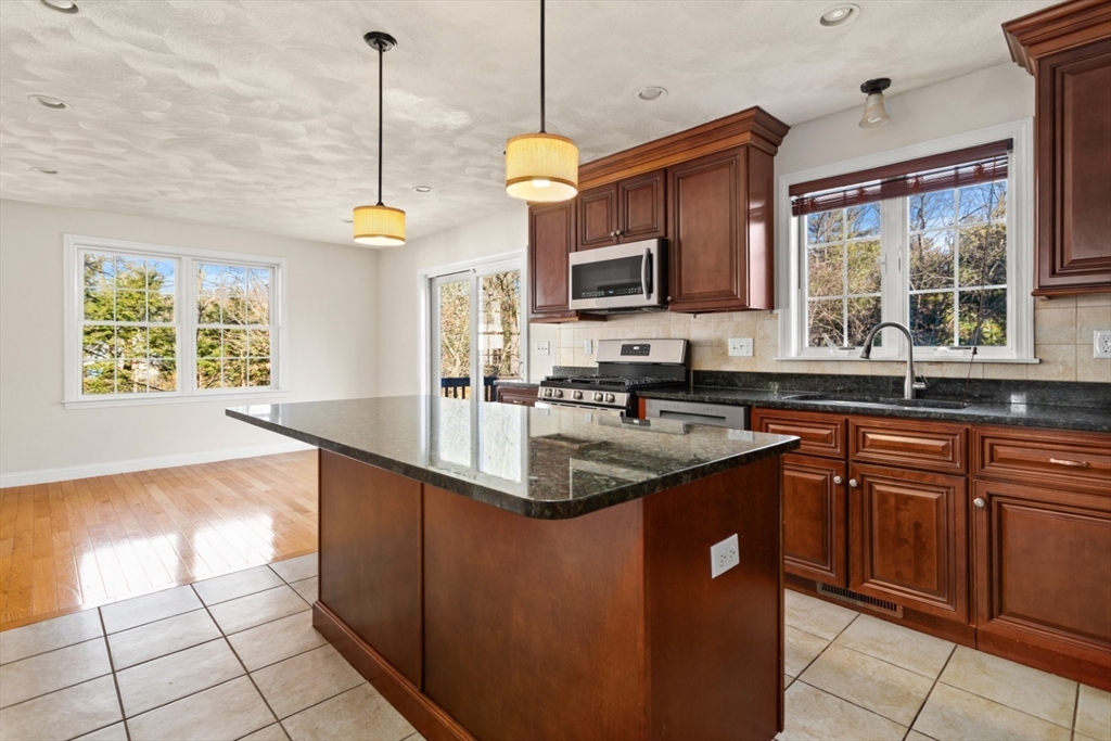 3 Gordon Road North Reading, MA 01864 - Photo 12 of 38 a kitchen with stainless steel appliances granite countertop a sink a stove and a wooden floors
