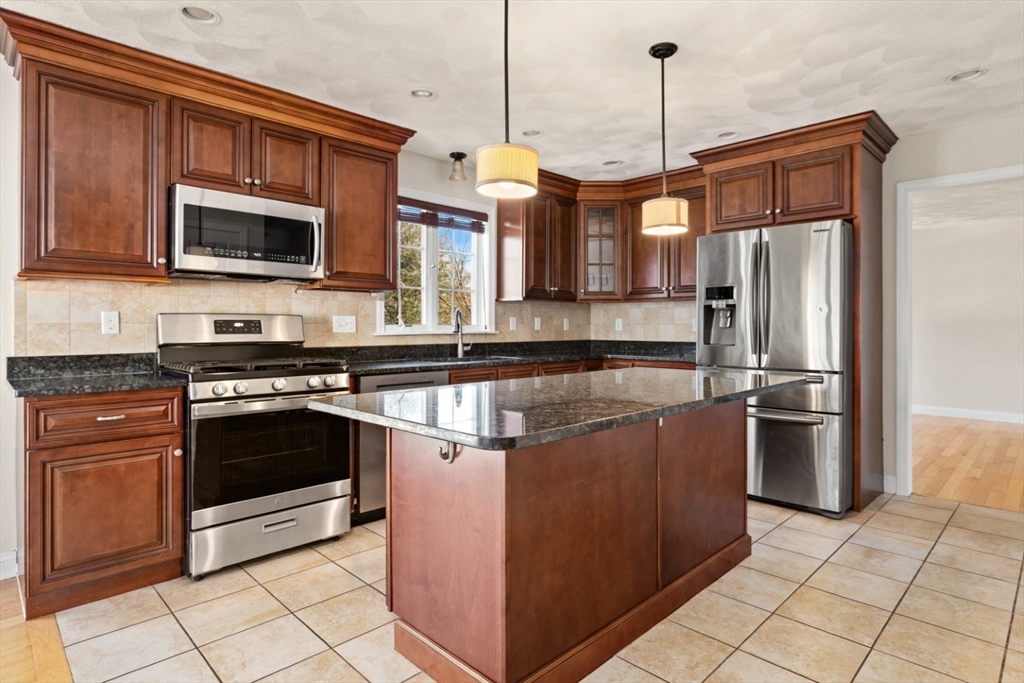 3 Gordon Road North Reading, MA 01864 - Photo 13 of 38 a kitchen with stainless steel appliances granite countertop a stove and a refrigerator