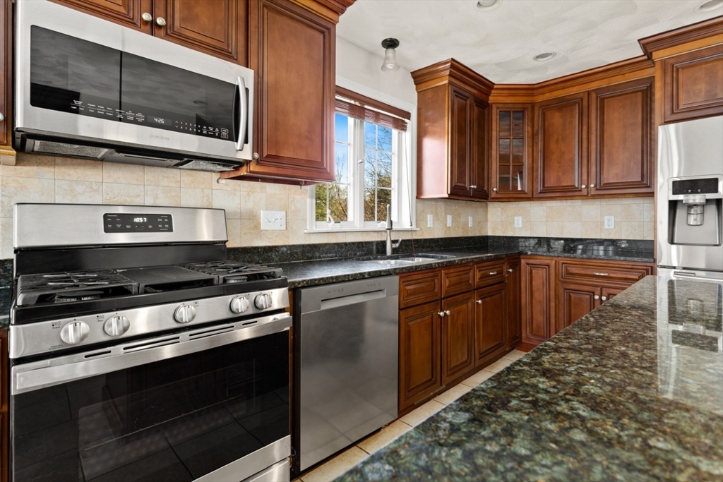 3 Gordon Road North Reading, MA 01864 - Photo 17 of 38 a kitchen with stainless steel appliances a stove microwave and cabinets