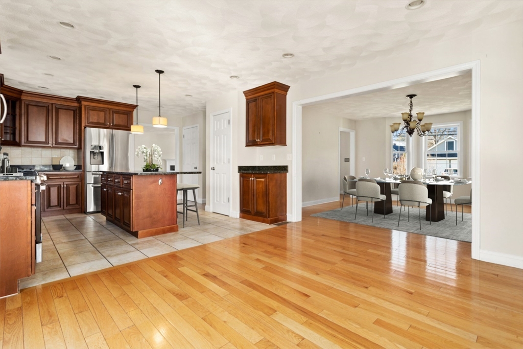 3 Gordon Road North Reading, MA 01864 - Photo 20 of 38 a living room with stainless steel appliances kitchen island granite countertop furniture and a fireplace
