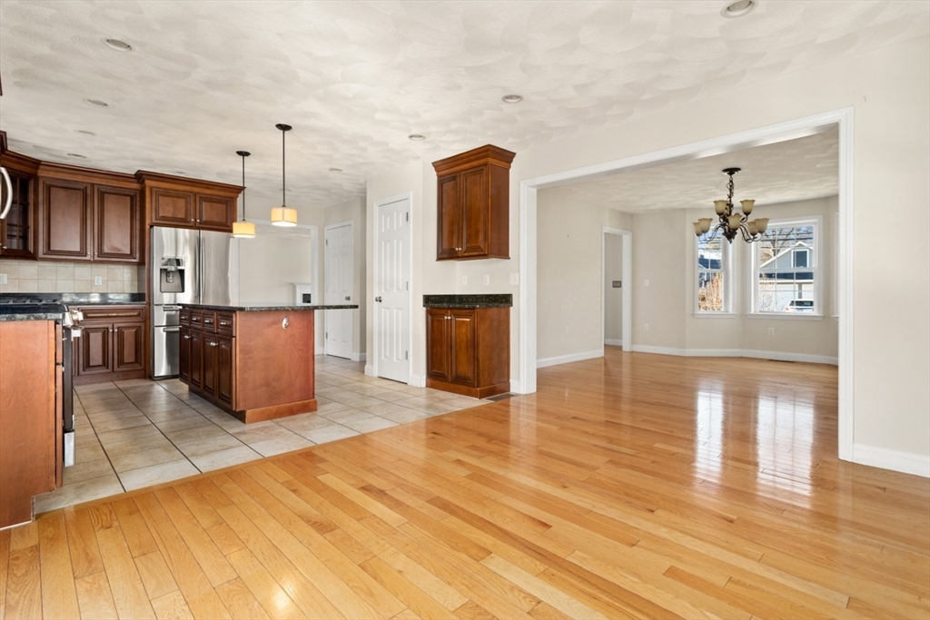 3 Gordon Road North Reading, MA 01864 - Photo 21 of 38 a view of a kitchen with kitchen island granite countertop wooden floor and stainless steel appliances