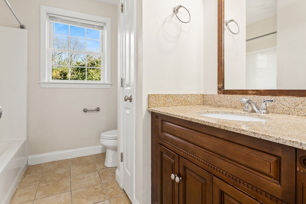 3 Gordon Road North Reading, MA 01864 - Photo 24 of 38 a bathroom with a granite countertop sink a toilet and a mirror