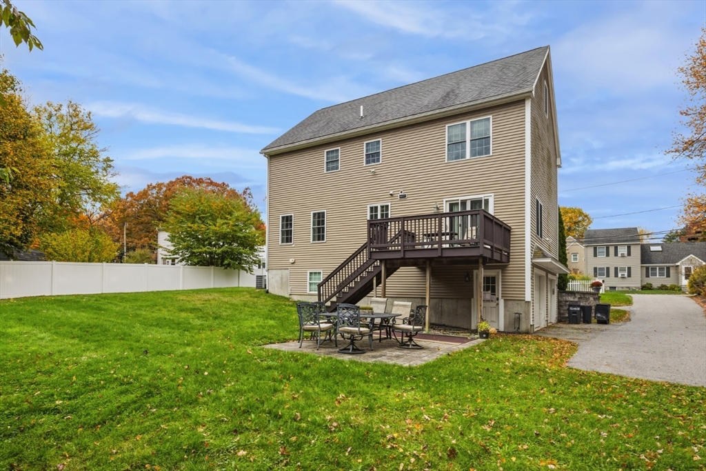3 Gordon Road North Reading, MA 01864 - Photo 36 of 38 a view of a backyard with a table and chairs