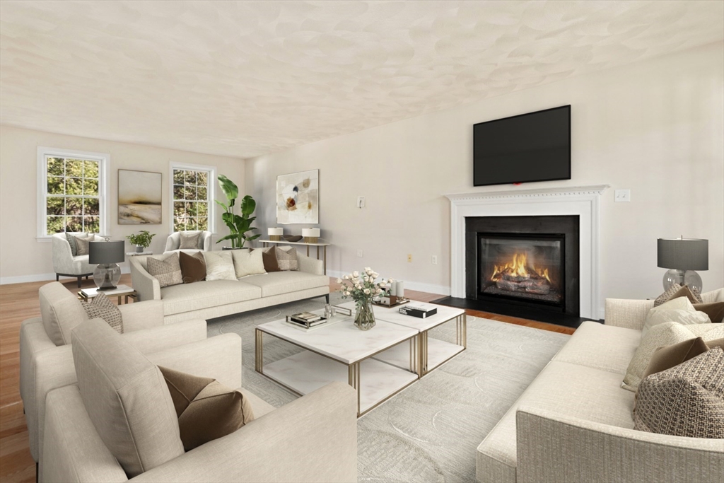 3 Gordon Road North Reading, MA 01864 - Photo 4 of 38 a living room with furniture a flat screen tv and a fireplace