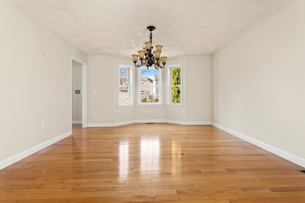 3 Gordon Road North Reading, MA 01864 - Photo 9 of 38 a view of an empty room with wooden floor and a window