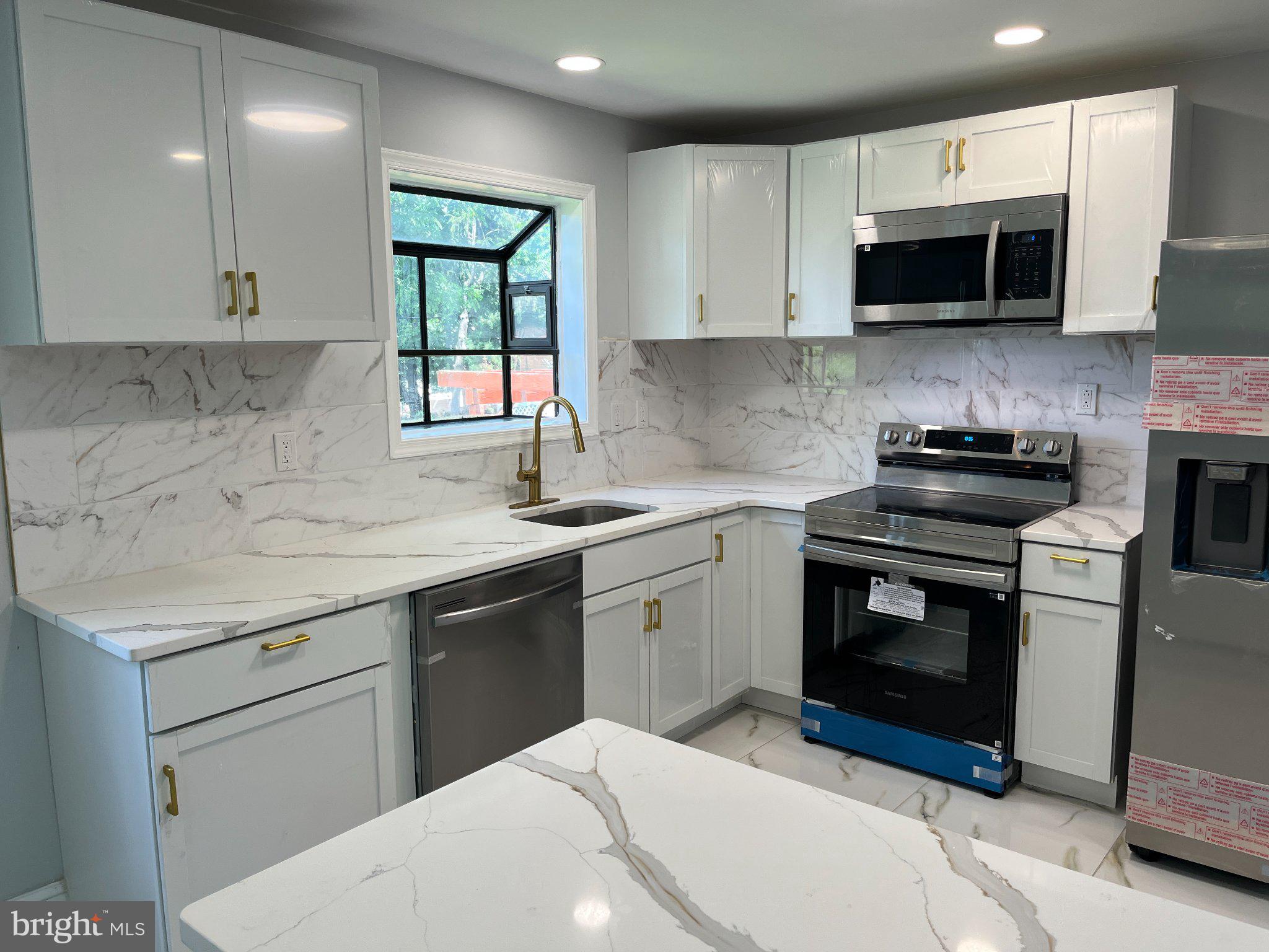 2405 Limestone Road Wilmington, DE 19808 - Photo 11 of 40 a kitchen with a sink stove and microwave