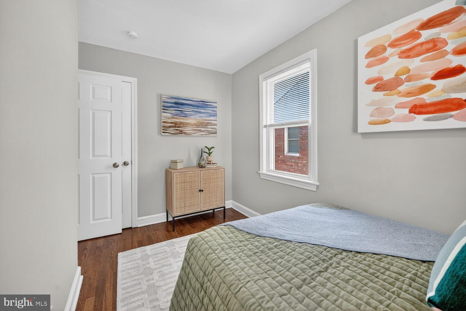 3433 25th Street Southeast Washington, DC 20020 - Photo 12 of 26 a bedroom with a bed and wooden floor