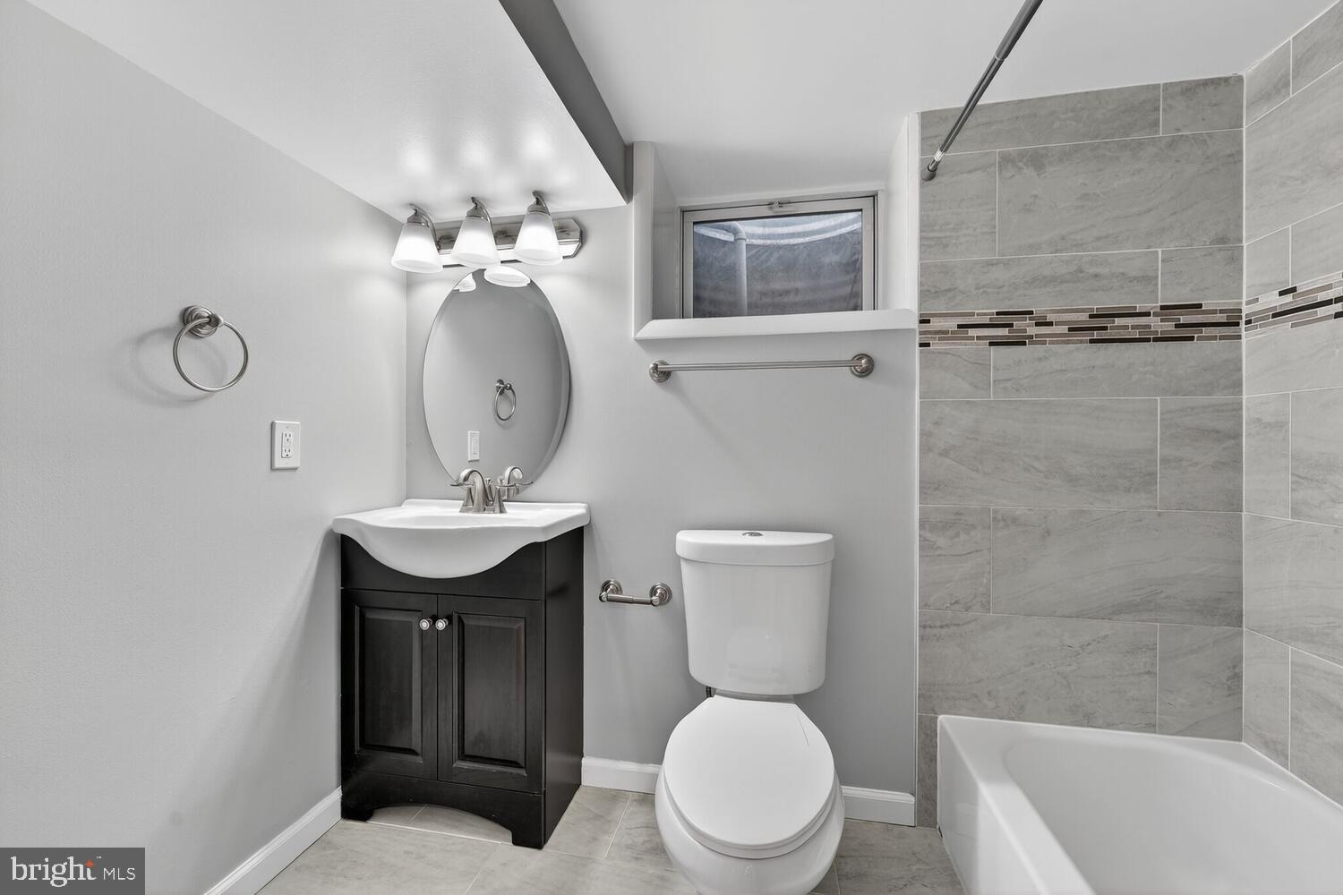 3433 25th Street Southeast Washington, DC 20020 - Photo 18 of 26 a bathroom with a toilet a sink and mirror