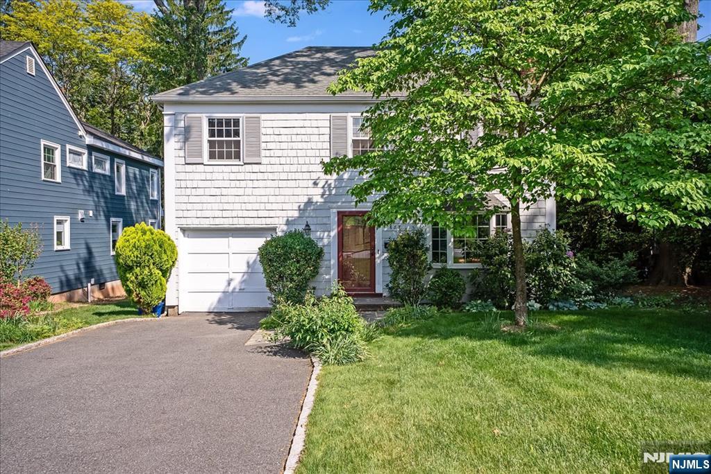 687 Grove Street Montclair, NJ 07043 - Photo 1 of 18 a front view of a house with a yard and a garden