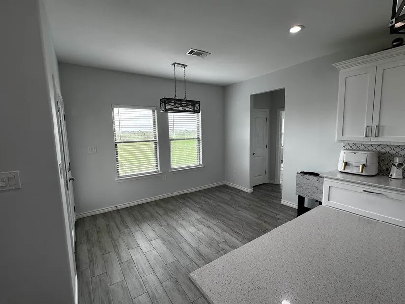 2295 Diamond D Lane Beaumont, TX 77713 - Photo 8 of 40 a kitchen with wooden floors and white walls
