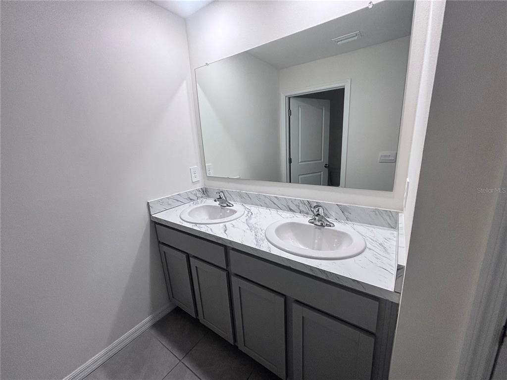 6730 Southeast 3rd Loop Ocala, FL 34472 - Photo 11 of 16 a bathroom with a sink and a mirror