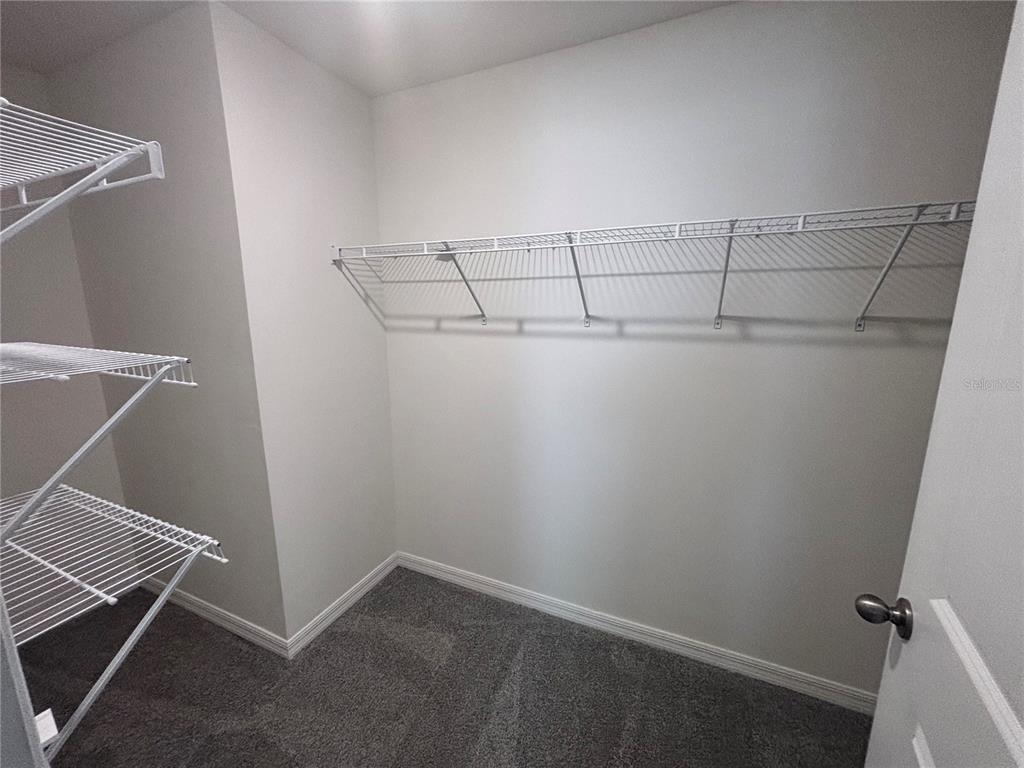 6730 Southeast 3rd Loop Ocala, FL 34472 - Photo 13 of 16 a view of a room with racks on the wall