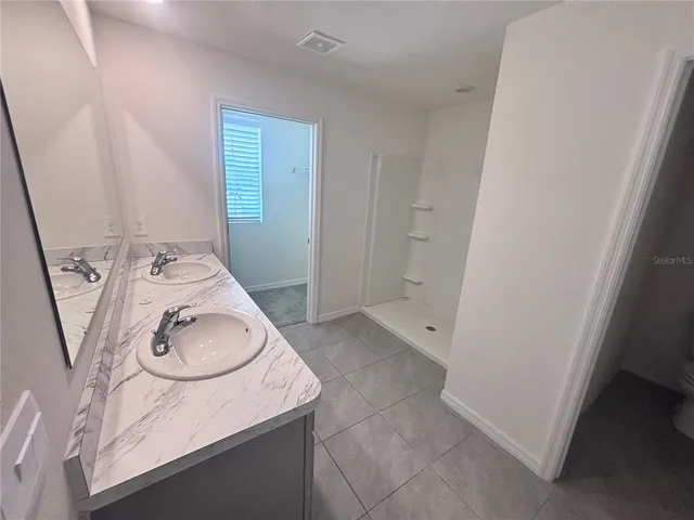 a bathroom with a sink a toilet and mirror