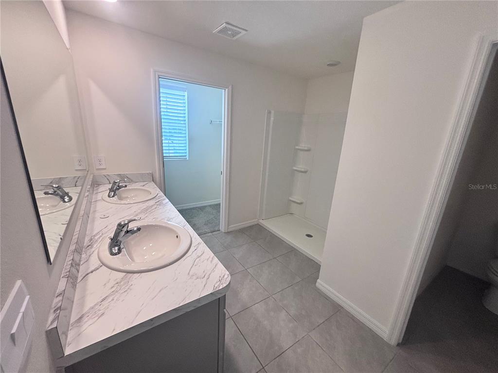 6730 Southeast 3rd Loop Ocala, FL 34472 - Photo 14 of 16 a bathroom with a sink a toilet and mirror