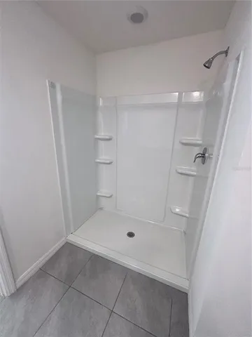 a bathroom with a sink and shower