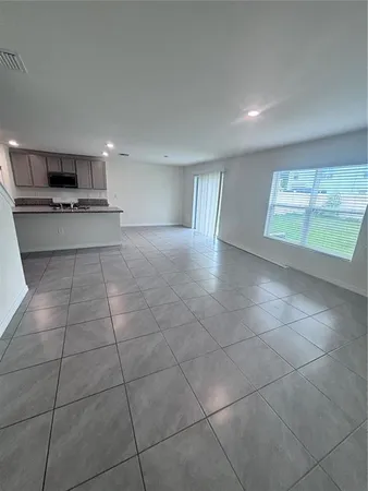 a view of a livingroom with an empty space and window