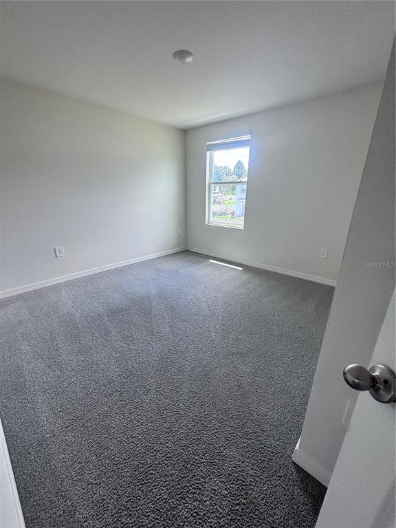 6730 Southeast 3rd Loop Ocala, FL 34472 - Photo 9 of 16 an empty room with windows