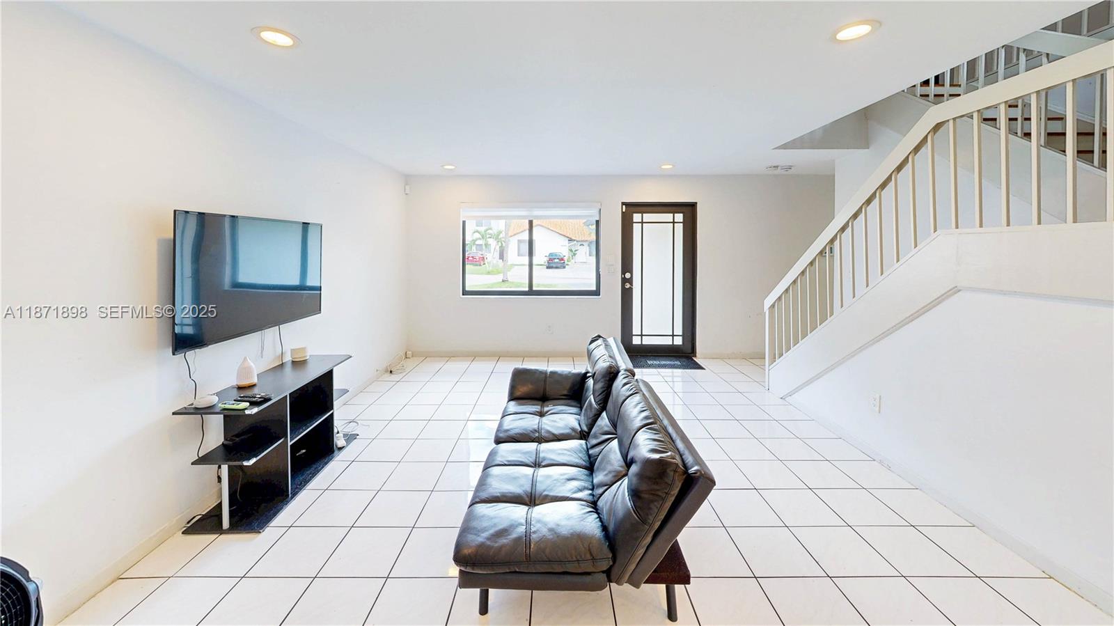 15166 Southwest 94th Terrace Miami, FL 33196 - Photo 12 of 83 a living room with furniture and a flat screen tv