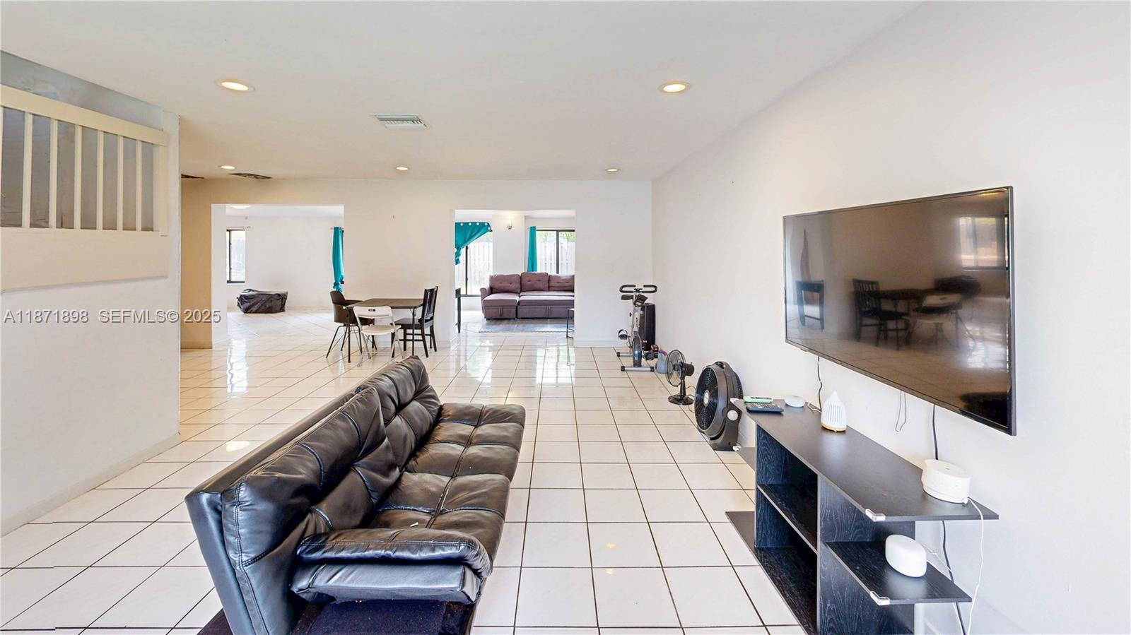 15166 Southwest 94th Terrace Miami, FL 33196 - Photo 18 of 83 a living room with furniture and a flat screen tv