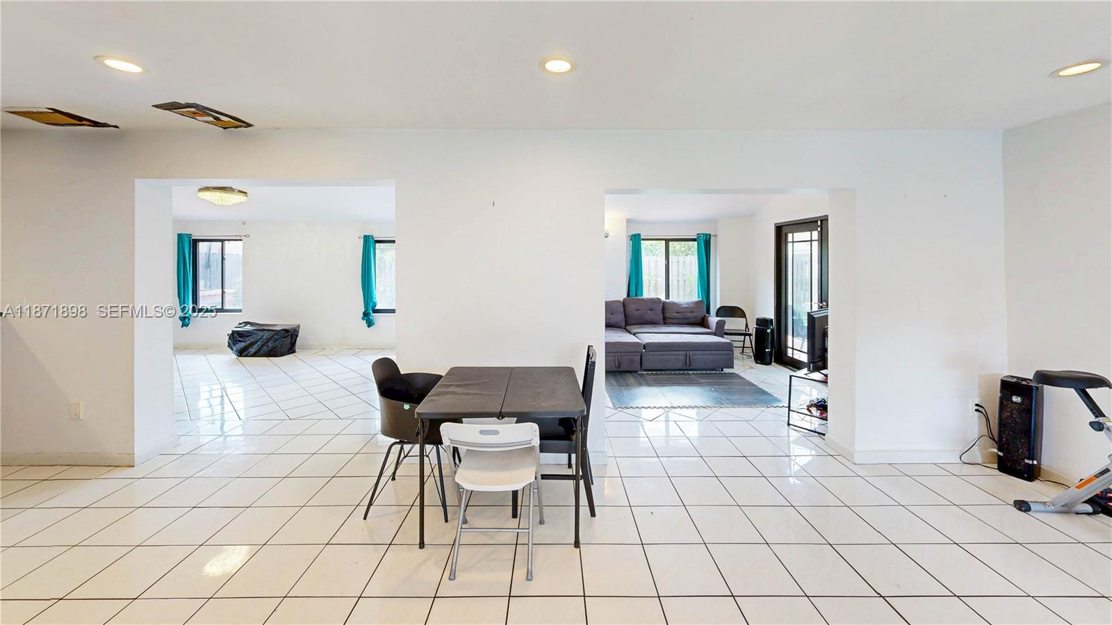 15166 Southwest 94th Terrace Miami, FL 33196 - Photo 19 of 83 a living room with furniture and a flat screen tv