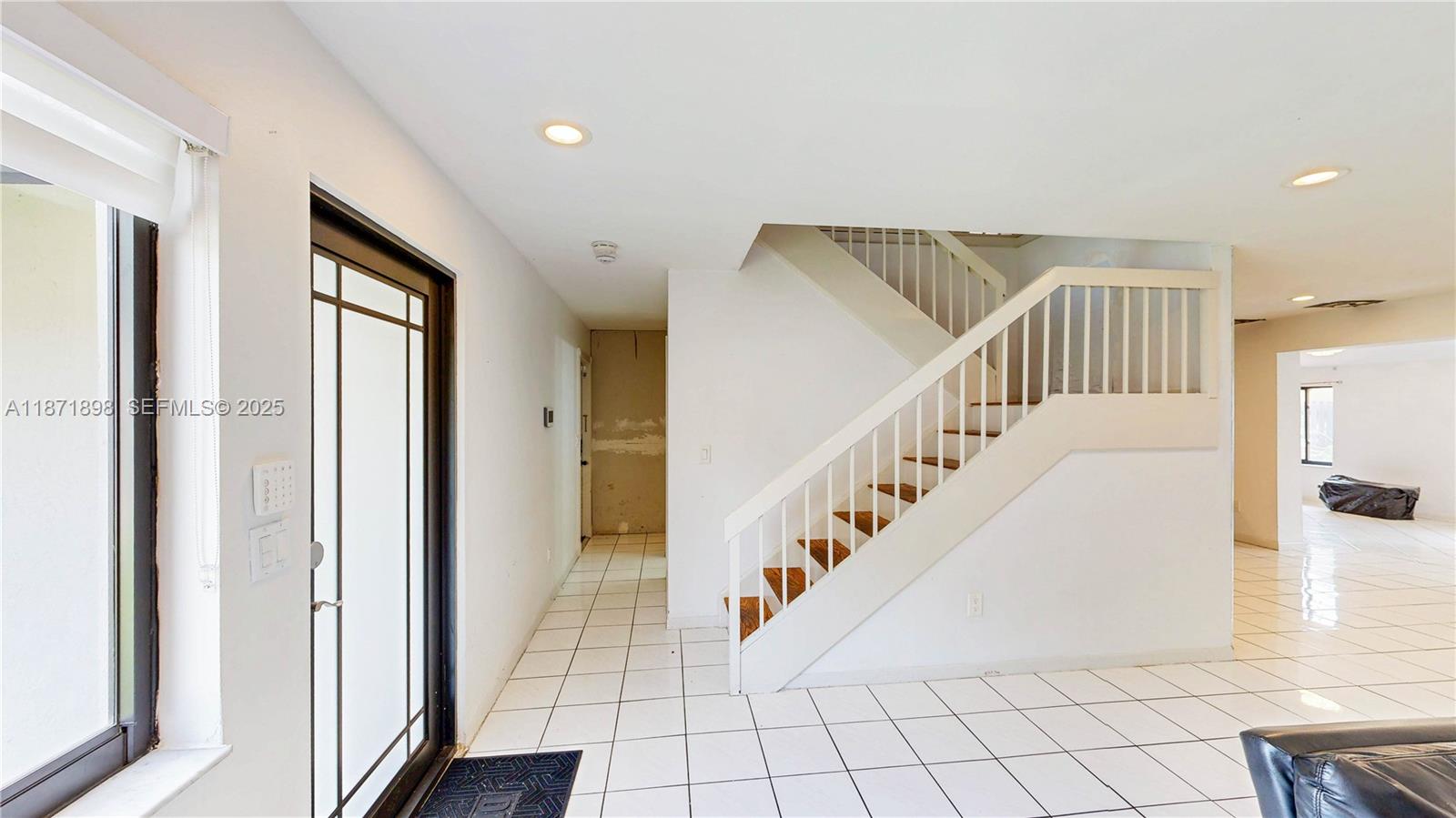 15166 Southwest 94th Terrace Miami, FL 33196 - Photo 31 of 83 a view of staircase with lots of frames on wall and a large window
