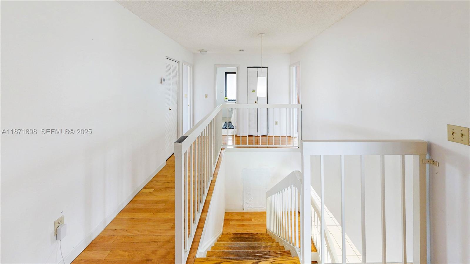 15166 Southwest 94th Terrace Miami, FL 33196 - Photo 33 of 83 a view of a hallway with wooden floor and staircase