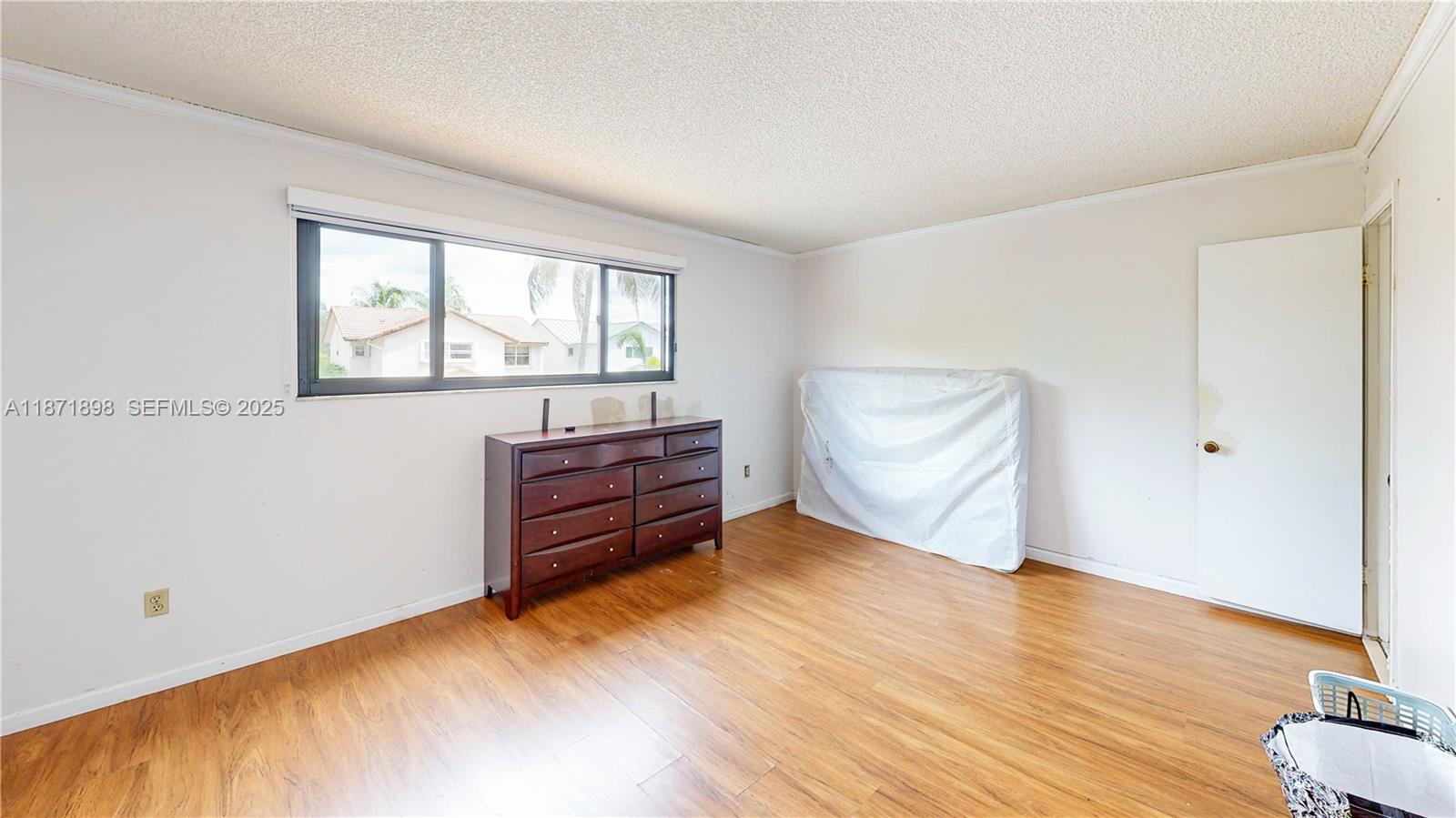 15166 Southwest 94th Terrace Miami, FL 33196 - Photo 38 of 83 an empty room with wooden floor and windows