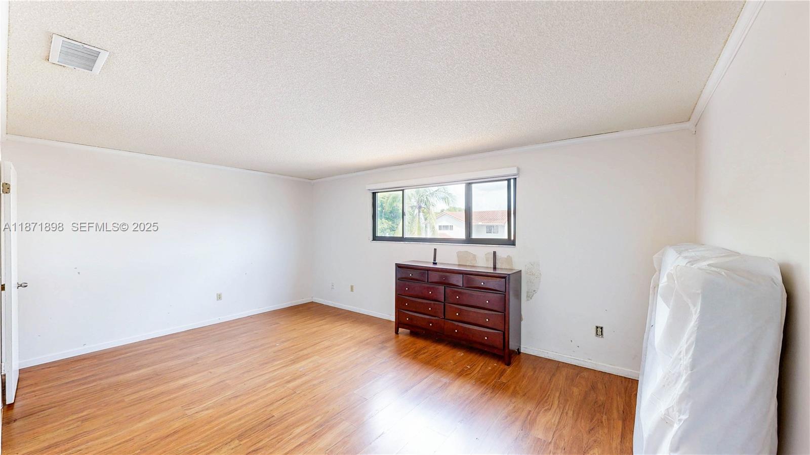 15166 Southwest 94th Terrace Miami, FL 33196 - Photo 42 of 83 a view of room with wooden floor and cabinet