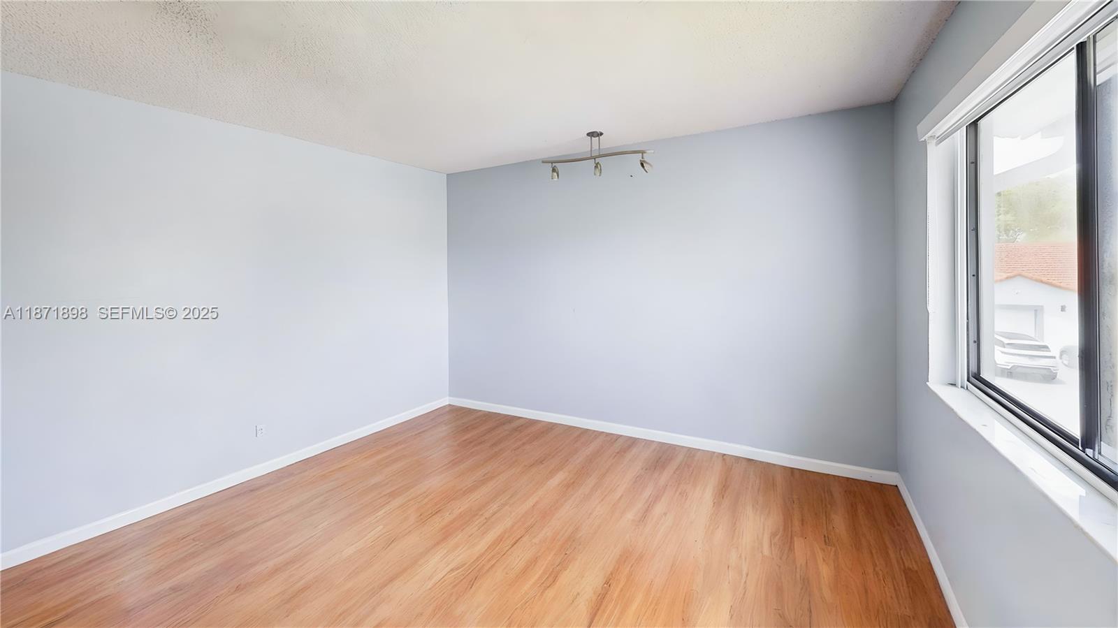 15166 Southwest 94th Terrace Miami, FL 33196 - Photo 45 of 83 a view of a room with wooden floor and windows
