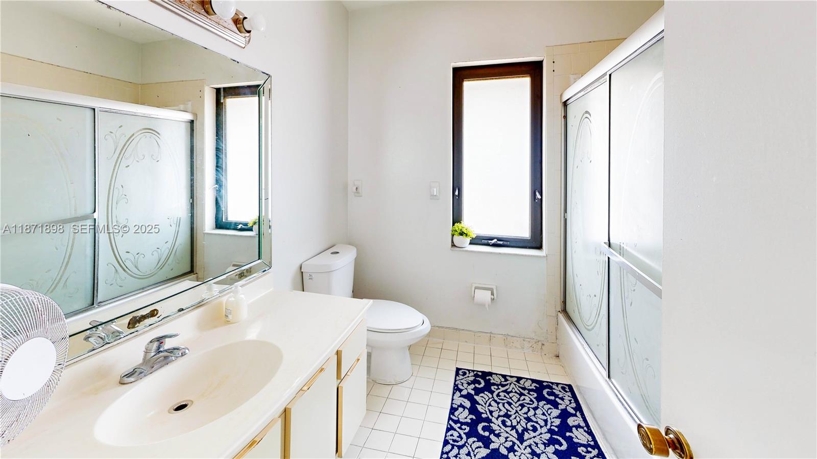 15166 Southwest 94th Terrace Miami, FL 33196 - Photo 48 of 83 a bathroom with a sink and a mirror