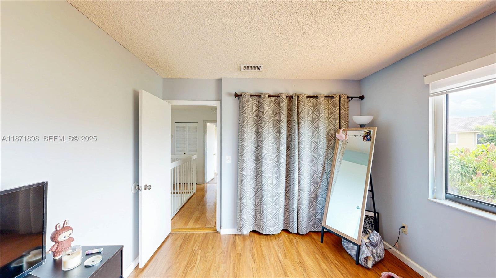 15166 Southwest 94th Terrace Miami, FL 33196 - Photo 52 of 83 a view of a hallway with wooden floor and bathroom