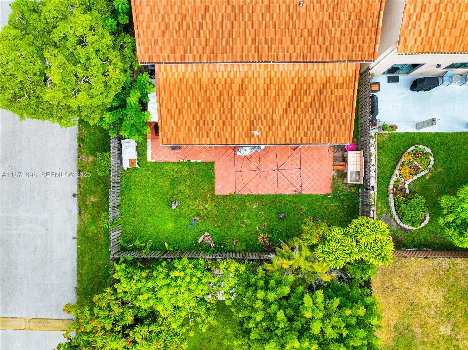 15166 Southwest 94th Terrace Miami, FL 33196 - Photo 67 of 83 a green field with flowers in front of it