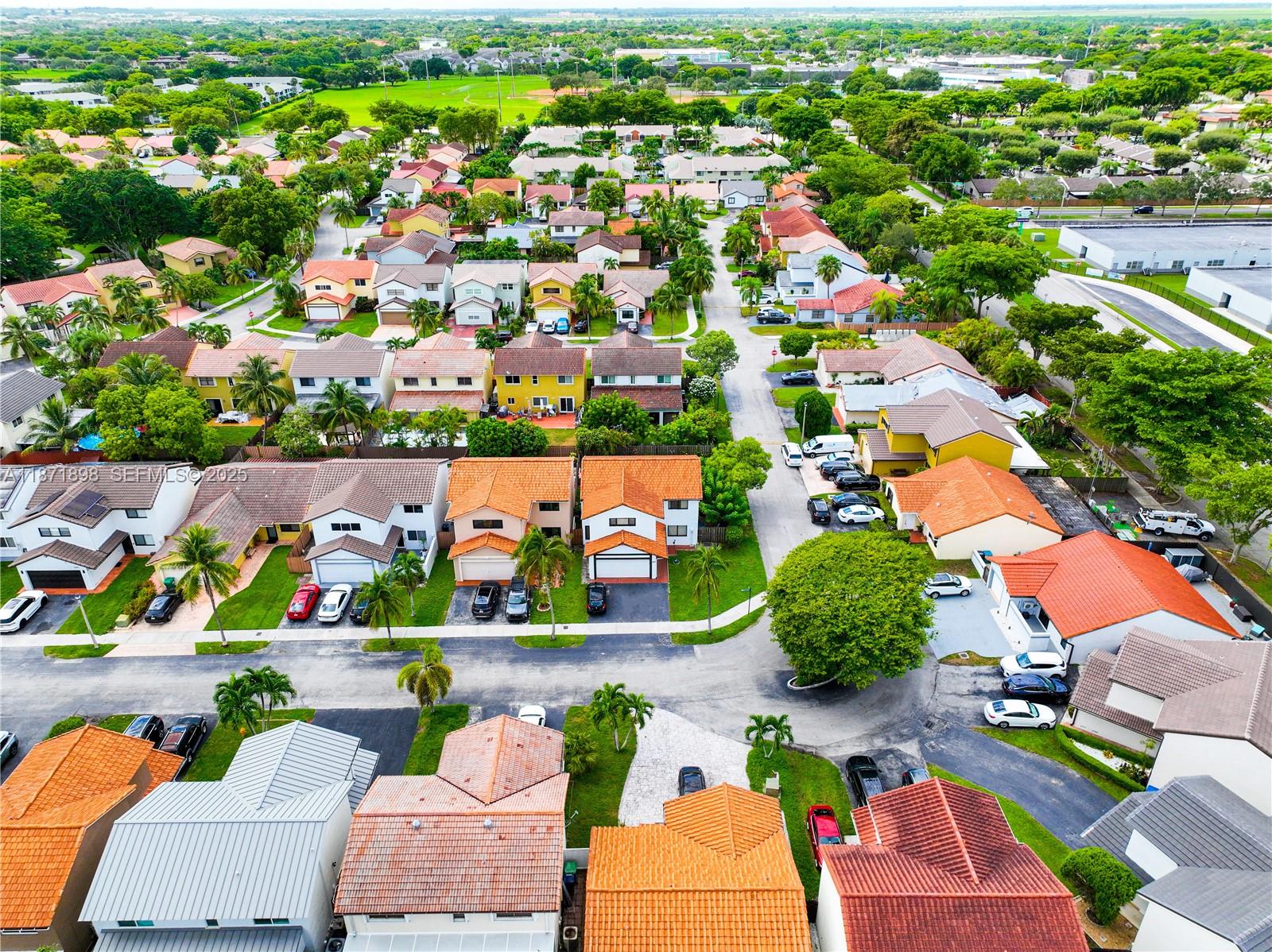 15166 Southwest 94th Terrace Miami, FL 33196 - Photo 74 of 83 an aerial view of residential houses with outdoor space and parking