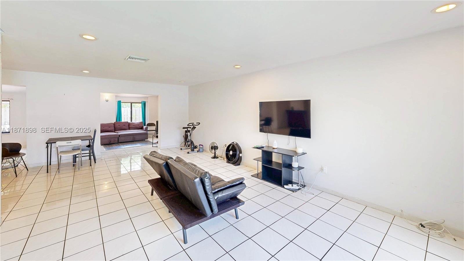 15166 Southwest 94th Terrace Miami, FL 33196 - Photo 8 of 83 a living room with furniture and a flat screen tv