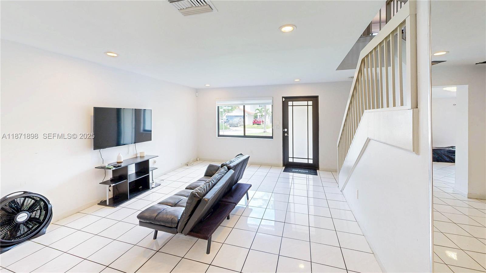 15166 Southwest 94th Terrace Miami, FL 33196 - Photo 9 of 83 a living room with furniture and a flat screen tv