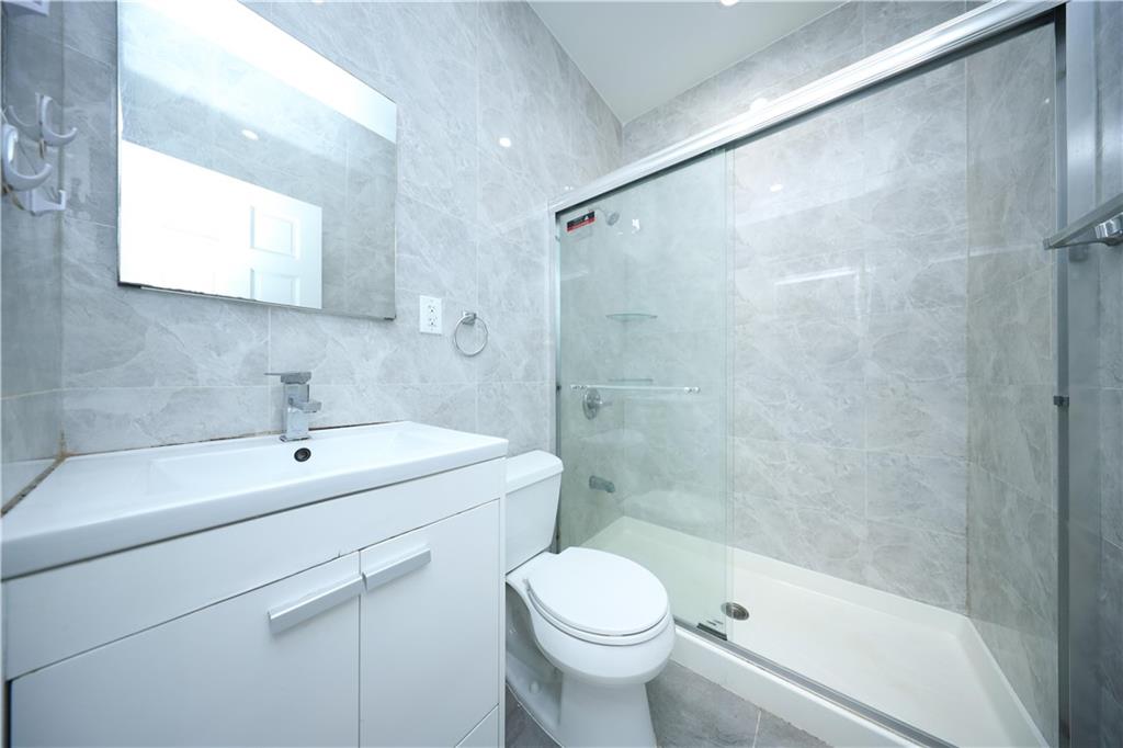 522 81 Street Brooklyn, NY 11209 - Photo 13 of 42 a bathroom with a sink toilet and shower