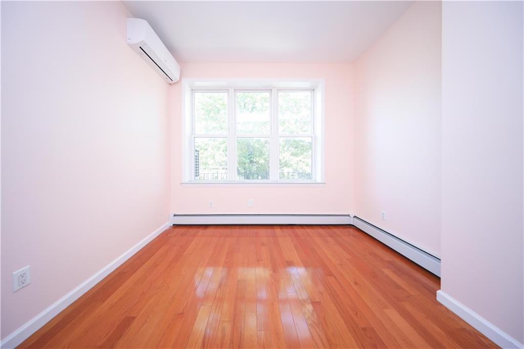 522 81 Street Brooklyn, NY 11209 - Photo 16 of 42 an empty room with a window and wooden floor