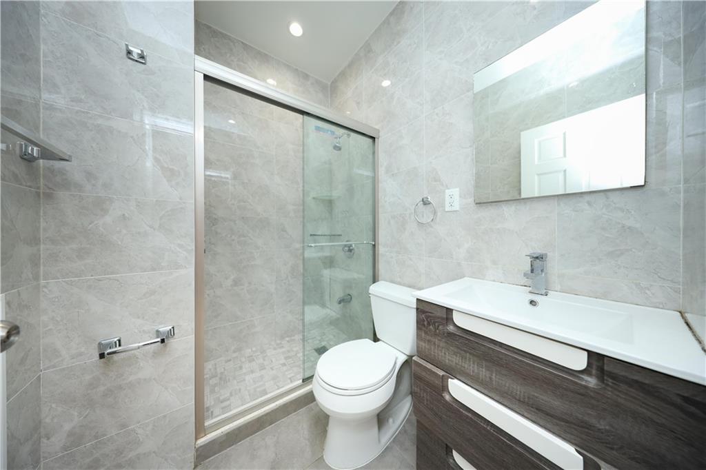 522 81 Street Brooklyn, NY 11209 - Photo 17 of 42 a bathroom with a sink a toilet and shower