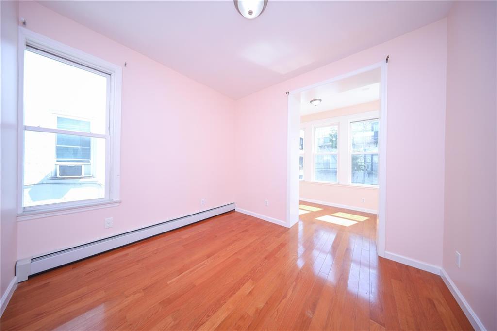 522 81 Street Brooklyn, NY 11209 - Photo 18 of 42 a view of an empty room with wooden floor and a window
