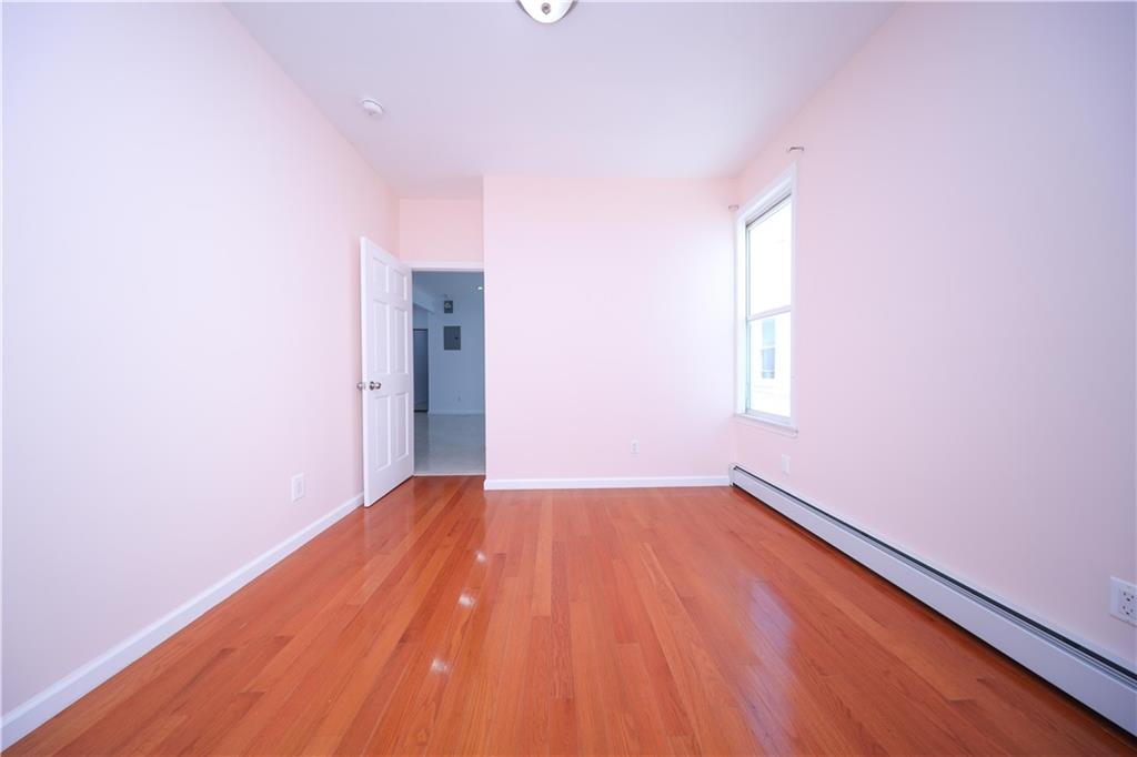 522 81 Street Brooklyn, NY 11209 - Photo 19 of 42 a view of empty room with wooden floor and fan