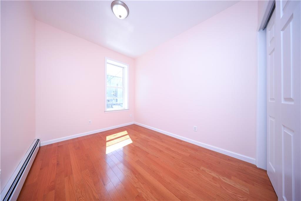 522 81 Street Brooklyn, NY 11209 - Photo 20 of 42 an empty room with wooden floor and windows