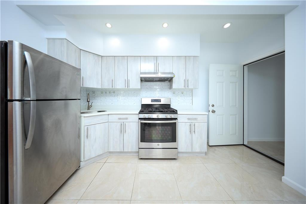 522 81 Street Brooklyn, NY 11209 - Photo 22 of 42 a kitchen with a stove and a refrigerator