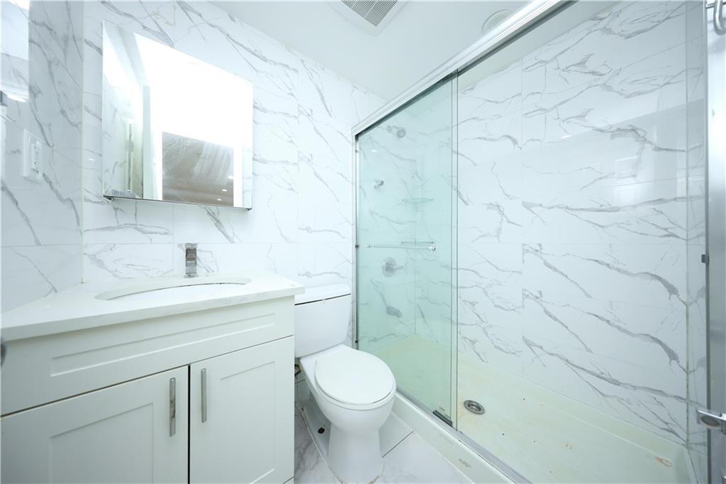 522 81 Street Brooklyn, NY 11209 - Photo 26 of 42 a bathroom with a sink a toilet and shower