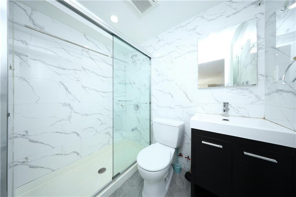 522 81 Street Brooklyn, NY 11209 - Photo 29 of 42 a bathroom with a sink toilet and shower