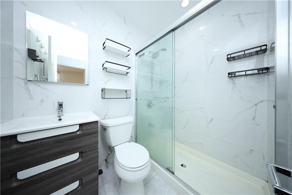 522 81 Street Brooklyn, NY 11209 - Photo 32 of 42 a bathroom with a sink a toilet and shower