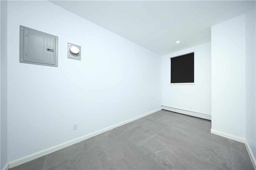 522 81 Street Brooklyn, NY 11209 - Photo 33 of 42 an empty room with a flat screen tv