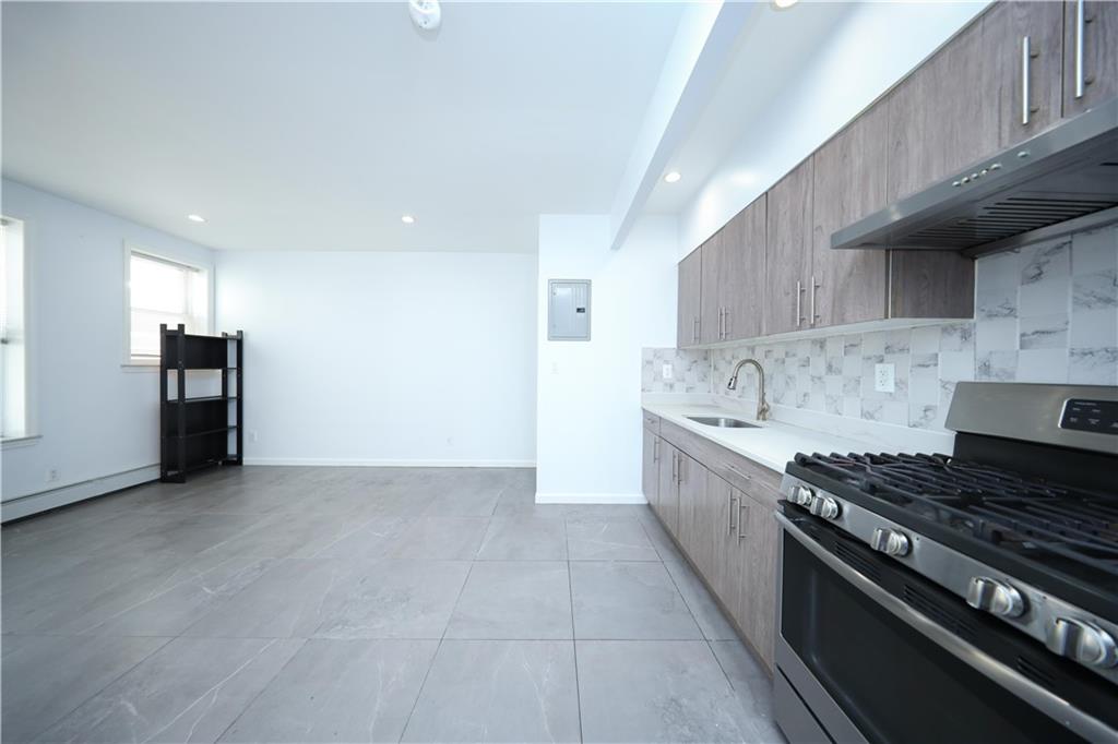522 81 Street Brooklyn, NY 11209 - Photo 8 of 42 a kitchen with stainless steel appliances granite countertop a stove a sink and a refrigerator